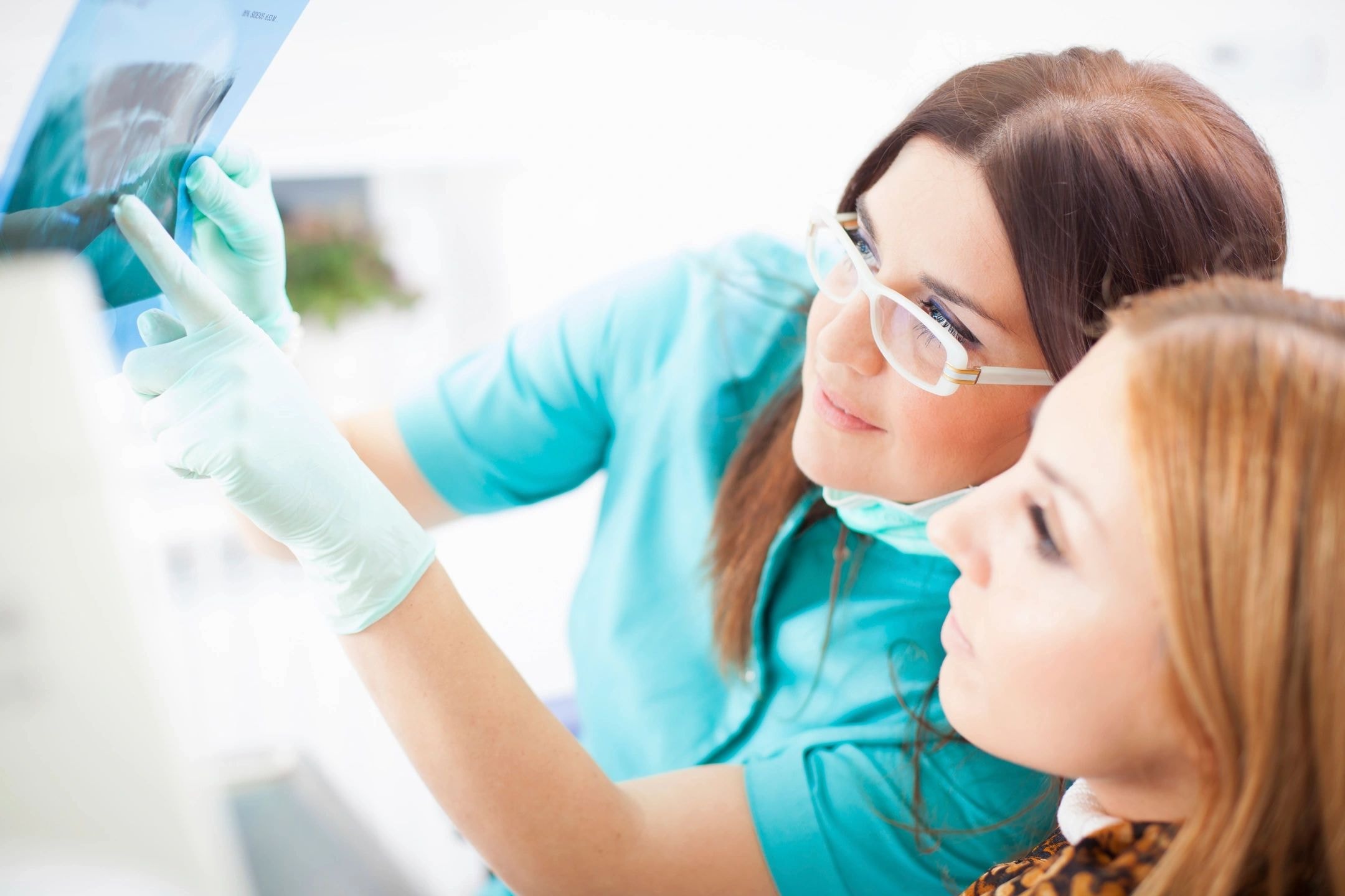 Dental professionals examining a patient
